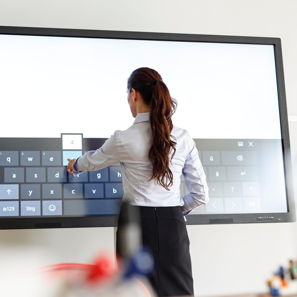 Leraar gebruikt een interactief digibord in de klas